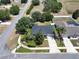 This is an aerial view of a home with well-kept landscaping and a paved driveway at 31920 Parkdale Dr, Leesburg, FL 34748