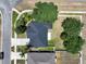 An aerial view of a well-kept home showcasing mature trees and a fenced backyard at 31920 Parkdale Dr, Leesburg, FL 34748