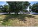Expansive backyard with mature trees and a white fence, creating a private outdoor space at 31920 Parkdale Dr, Leesburg, FL 34748