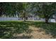 Spacious backyard surrounded by mature trees and a white fence, offering privacy and natural beauty at 31920 Parkdale Dr, Leesburg, FL 34748