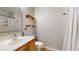 A clean and functional bathroom with modern fixtures, a sink, toilet, shower, and shelving at 31920 Parkdale Dr, Leesburg, FL 34748