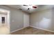 Neutral bedroom featuring carpet floors, a ceiling fan, and a closet at 31920 Parkdale Dr, Leesburg, FL 34748