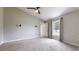 A cozy bedroom with a ceiling fan, natural light, and a view of the outside through a window at 31920 Parkdale Dr, Leesburg, FL 34748