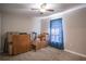 Bedroom needing some TLC, with carpeted floors, boxes and a ceiling fan at 31920 Parkdale Dr, Leesburg, FL 34748