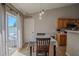 Bright dining area with sliding door access to outdoor seating and adjacent kitchen at 31920 Parkdale Dr, Leesburg, FL 34748