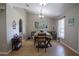 Inviting dining area featuring wood flooring, a modern light fixture, and elegant decor at 31920 Parkdale Dr, Leesburg, FL 34748