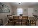 Dining room with a large table, wood floors, and natural light from the front door at 31920 Parkdale Dr, Leesburg, FL 34748