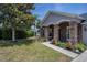 Charming home featuring stone accents, a well-manicured lawn, and beautiful landscaping at 31920 Parkdale Dr, Leesburg, FL 34748