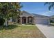 Charming home featuring stone accents, a well-manicured lawn, and a two-car garage at 31920 Parkdale Dr, Leesburg, FL 34748