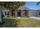 Charming home featuring stone accents, a well-manicured lawn, and a two-car garage at 31920 Parkdale Dr, Leesburg, FL 34748