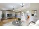Staged living room with wood floors, archways, and an open floor plan leading to the kitchen at 31920 Parkdale Dr, Leesburg, FL 34748