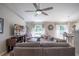 Spacious living room with a large sectional, ceiling fan, and backyard views at 31920 Parkdale Dr, Leesburg, FL 34748
