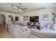 Expansive living room with a large sectional, wood floors, and neutral paint colors at 31920 Parkdale Dr, Leesburg, FL 34748