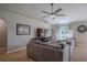 Comfortable living room featuring a large sectional, wood floors, and a ceiling fan at 31920 Parkdale Dr, Leesburg, FL 34748