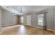 Bright living room featuring wood floors, neutral walls, and two windows flanking the entry door at 31920 Parkdale Dr, Leesburg, FL 34748