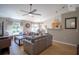 Open concept living room with kitchen views, ceiling fan, and backyard access at 31920 Parkdale Dr, Leesburg, FL 34748