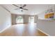 Bright living room with wood-look flooring, ceiling fan, and access to the backyard through sliding glass doors at 31920 Parkdale Dr, Leesburg, FL 34748
