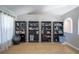 Cozy living space features multiple bookcases, wood floors, and neutral paint at 31920 Parkdale Dr, Leesburg, FL 34748