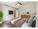 Stylishly decorated main bedroom with ensuite bathroom, a ceiling fan, and a comfortable bed at 31920 Parkdale Dr, Leesburg, FL 34748