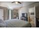 Large bedroom with private bath access, TV, and window view at 31920 Parkdale Dr, Leesburg, FL 34748