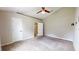 A spacious main bedroom with a ceiling fan, neutral walls, and an ensuite bathroom with a shower at 31920 Parkdale Dr, Leesburg, FL 34748