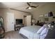 Spacious bedroom with a ceiling fan, TV, and ensuite bathroom at 31920 Parkdale Dr, Leesburg, FL 34748