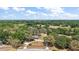 Expansive aerial view of estate surrounded by mature trees and landscaping, featuring a circular driveway at 32132 Hickory Ln, Sorrento, FL 32776