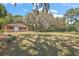 Large backyard showing building, trees, and grass at 32132 Hickory Ln, Sorrento, FL 32776