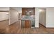 Wet bar features wood cabinets, granite counters, a tiled backsplash, wine fridge, and wood floors at 32132 Hickory Ln, Sorrento, FL 32776