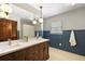 Bathroom with double sinks, stylish vanity, beadboard paneling and tile flooring at 32132 Hickory Ln, Sorrento, FL 32776
