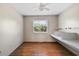Bedroom featuring wood-look floors, a window with built-in desk, and neutral walls at 32132 Hickory Ln, Sorrento, FL 32776