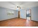 Bedroom with blue walls and wood-look floors with ensuite bathroom at 32132 Hickory Ln, Sorrento, FL 32776