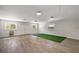Spacious bonus room features bright lighting, wood-look flooring, and ample space for activities at 32132 Hickory Ln, Sorrento, FL 32776
