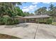 Charming single-story brick home featuring a well-manicured lawn and attached two-car garage at 32132 Hickory Ln, Sorrento, FL 32776