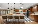 Spacious kitchen features wood cabinets, granite counters, a large island, and checkerboard floors at 32132 Hickory Ln, Sorrento, FL 32776