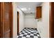 Laundry room with checkerboard floors, storage cabinets, closet with louvered door, and good lighting at 32132 Hickory Ln, Sorrento, FL 32776