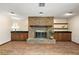 Cozy living room with a brick fireplace, built-in cabinets, and wood floors at 32132 Hickory Ln, Sorrento, FL 32776