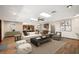 Spacious living room with elegant furnishings, a fireplace, bar, and plenty of natural light, perfect for relaxation and entertainment at 32132 Hickory Ln, Sorrento, FL 32776