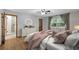 Bedroom with stylish décor, hardwood floors, ensuite bathroom and natural light at 32132 Hickory Ln, Sorrento, FL 32776