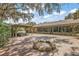 A spacious backyard patio area featuring a fire pit, covered seating, and beautiful views of the home at 32132 Hickory Ln, Sorrento, FL 32776
