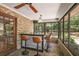 Enclosed patio with a brick wall, bar area with seating, and a view of the backyard at 32132 Hickory Ln, Sorrento, FL 32776
