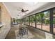 Enclosed patio with brick walls, ceiling fans, floor-to-ceiling windows, bar, and dining space at 32132 Hickory Ln, Sorrento, FL 32776
