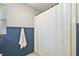 Shower with white tile and blue beadboard paneling at 32132 Hickory Ln, Sorrento, FL 32776