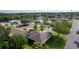 An aerial view showing a well-kept home with a lush green lawn nestled in a quiet residential neighborhood at 334 Shiloh Ct, The Villages, FL 32162