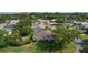 Aerial view showcasing the backyard and surrounding neighborhood with mature trees and landscaping at 334 Shiloh Ct, The Villages, FL 32162