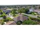 An aerial view of a home in a suburban neighborhood featuring mature trees, well-kept lawns, and quiet streets at 334 Shiloh Ct, The Villages, FL 32162