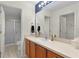 Bright bathroom featuring a vanity with wood cabinets, neutral countertops, and a tub with shower at 334 Shiloh Ct, The Villages, FL 32162