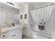 Bathroom features white vanity, a large mirror, and a tub with a shower and decorative curtain at 334 Shiloh Ct, The Villages, FL 32162