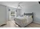 Cozy bedroom with a ceiling fan, and sunlight streaming through the window with decorative curtains at 334 Shiloh Ct, The Villages, FL 32162