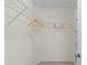 Walk-in closet boasts wire shelving for optimal storage and organization, and features three wooden hangers at 334 Shiloh Ct, The Villages, FL 32162